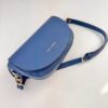 Indigo blue Alma bag photographed at a diagonal angle