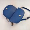 View of the open Indigo blue Alma bag, revealing the closure magnet