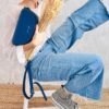 Model holds the Indigo blue Alma bag in a relaxed way