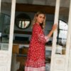 Side view of the Jaase French Ruby Rouge mini dress, highlighting its loose fit and puffed three-quarter sleeves