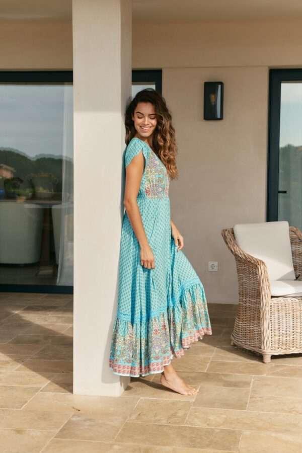 Side view of the Jaase Carmen Atlantis dress showing the flounced hem and lace details