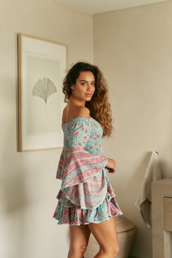Side profile of the Jaase Primrose dress featuring smocked bodice and tiered skirt